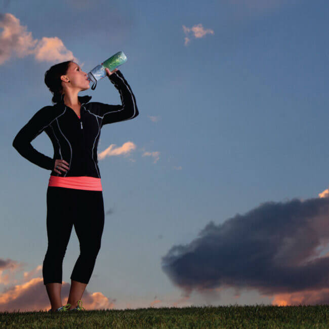 Woman drinking out of Polar Bottle water bottle